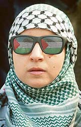 An anti-war protester wears sunglasses showing the Palestinian flag whilst listening to speeches during a peace rally in Hyde Park, London, on Saturday. 
