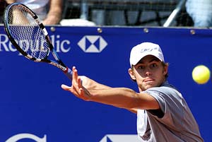 Andy Roddick of the US returns a ball during his match against Albert Portas of Spain 