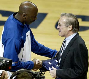 US Defence Secretary Donald Rumsfeld presents Washington Wizards' Michael Jordan with an American flag that flew at the Pentagon on September 11, 2002,