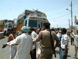 Truck drivers block the way of a convoy of trucks