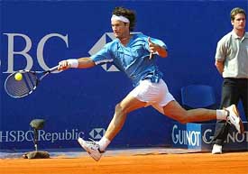 Carlos Moya of Spain makes a forehand return against Julien Boutter of France 