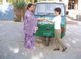 Ritu Suri of Step by Step Nursery School handing over a three-wheeler to Dr S. Y. Devi