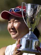 Candie Kung of Taiwan, who won the LPGA Takefuji Classic golf tournament, holds the trophy at the Las Vegas Country Club 