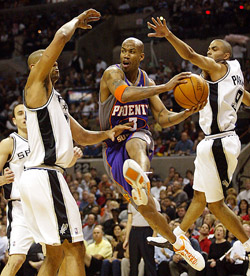 Phoenix Suns' Stephon Marbury attempts to pass the ball as San Antonio Spurs' Time Duncan and Tony Parker try to block him 