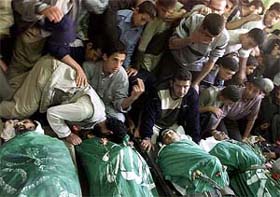 Palestinians pay tribute to the five Palestinians killed during a raid by Israeli troops 