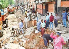 Municipal Corporation staff remove encroachments on the road berm in the back lane of Sector 35 hotels