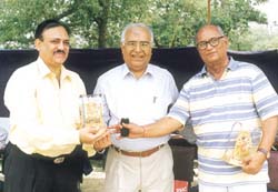 Gyan Bharti School (Saket) Principal R. C. Sekhar honouring National Cricket Academy vice-chairman C. K. Khanna (left) and Board of Control for Cricket in India joint-secretary Jyoti Bajpai for their valuable contribution to cricket.