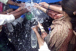 Delegates filling their bottles and containers to quench thirst 