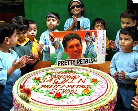 Children cut a 30-kg cake to celebrate master blaster Sachin Tendulkar's 30th birthday