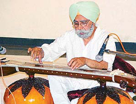 Dehra Dun-based artiste Ajit Singh plays the vichitra veena at the English Auditorium, Panjab University, Chandigarh, on Friday.