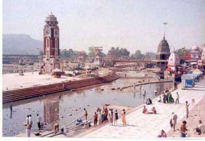 Devotees take bath through pipes at Har-ki-Pauri in Hardwar on Friday