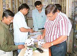 A team of the State Drug Control Department seals samples at a chemist�s shop