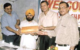 National Akali Dal president Paramjit Singh Pamma presenting a cheque of Rs 15,000 to the Chief Fire Officer, Mr R C Sharma, during the Fire Safety Week 