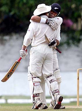 New Zealand captain Stephen Fleming is embraced by team-mate Scott Styris after Fleming reached his 200
