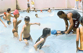 Students making the most of the summer heat in their campus pool