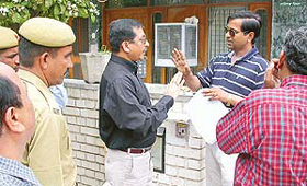 Officials of  Allahabad Bank argue with Mr Harbilas Jindal�s son when they went to serve a notice under SAROFA in Panchkula  on Sunday.