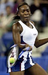 Venus Williams of the USA hits a forehand return against Daja Bedanova of the Czech Republic