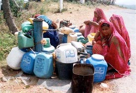 Due to an acute shortage of water in the summer season, women wait for water with their utensils
