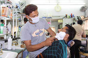 A barber uses surgical mask in fear of SARS