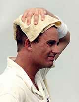 New Zealand fast bowler Shane Bond wipes his head 