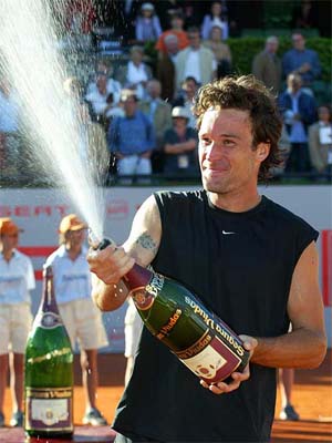 Carlos Moya of Spain sprays champagne after defeating Marat Safin of Russia in the finals of the Godo Tennis Open 