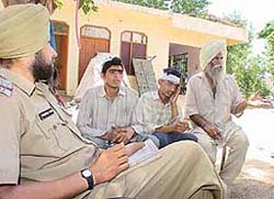Mr Bhola Singh (right) and his two grandsons give a statement to the police about a robbery bid at their house in Salamatpur village in Kharar 