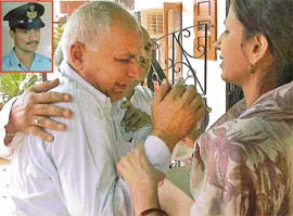 Ms Anu Tomar, sister-in-law of Kishan Tomar (inset), consoles the deceased�s father-in-law at the Tomars� Sector 11 residence in Panchkula 
