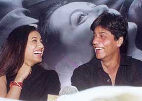 Bollywood star Shah Rukh Khan shares a joke with actress Rani Mukharjee