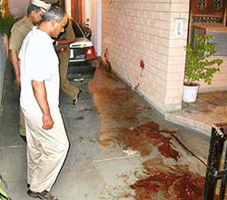 The SP, Panchkula, Mr Ranbir Singh, examines the blood-stained floor of the Sector 15 residence of HCS officer Bhoop Singh Bishnoi, whose wife Sudesh Bala Bishnoi was  clubbed to death by her servant, who later shot himself on Wednesday.