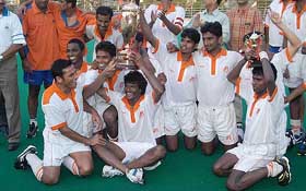The jubilant Indian Airlines team with the 41st Bombay Gold Cup hockey trophy