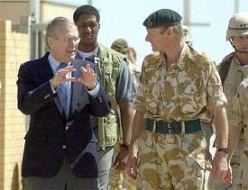 US Defence Secretary Donald Rumsfeld, left, speaks with British officer Major General Robin Brimms