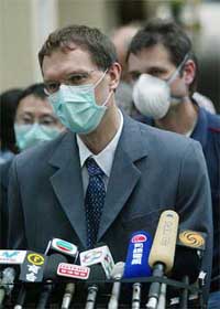 Dr Udo Buchholz from the World Health Organisation wears a mask to protect himself from the SARS virus