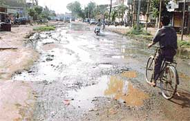 Stretch of road damaged due to chemical and metal mixed effluent discharge