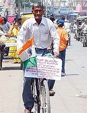 Ex-serviceman Nathiprasad Nainwal spreads the message of peace and love on his cycle