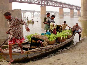 A vegetable seller steps out of his boat