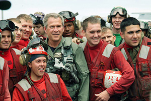 President George W. Bush meets crew members on the deck of aircraft carrier USS Abraham Lincoln