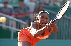 Venus Williams of the US hits a backhand during her quarterfinal match against Franceska Schiavone of Italy 