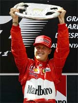 German Formula One driver Michael Schumacher raises the trophy after winning the Spanish Grand Prix 