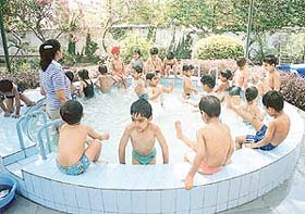 Children of Strawberry Fields ride high on enthusiasm as they splash around in the paddling pool in school on Monday morning.