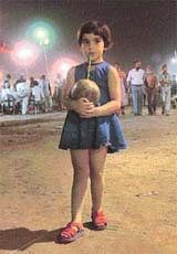 A girl enjoys coconut water on the concluding day of the trade and cultural fair
