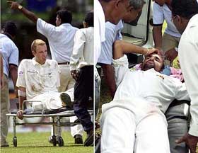 New Zealand's Daniel Vettori and Sri Lanka's Marvan Atapatttu lie on stretchers as medical staffs carry them to an ambulance