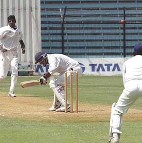 Sairaj Bahutule ducks a bouncer from Tamil Nadu captain S. Suresh on the first day of the Ranaji Trophy finals 