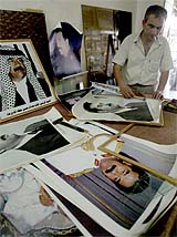 Omer al-Samhouru puts finishing touches to a picture of ousted Iraqi President Saddam Hussein 