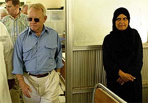 US General Jay Garner walks through a women's ward at the Basra general hospital 