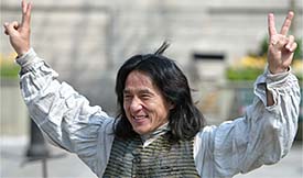Chinese actor Jackie Chan flashes victory signs 