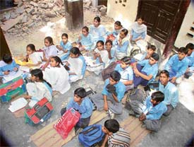 Students of Government High School, Chewni Mohalla, Ludhiana, sit in an open verandah