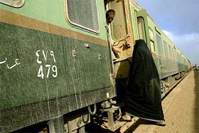 An Iraqi woman boards a carriage at Baghdad Central railway station 