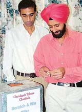 Mr Ramandeep Singh, Branch Head and Mr S.K. Mahajan, Service Head, Consumer Electronics, Chandigarh, at the draw of the �Scratch and Win Offer� of Chandigarh Tribune.