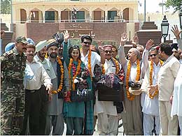 Pakistani parliamentarians wave after crossing into India at Wagha 