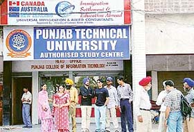 Students and their parents stand outside the PTU study centre in Sector 47, Chandigarh, on Friday, following confusion that the private computer institution had been closed down.